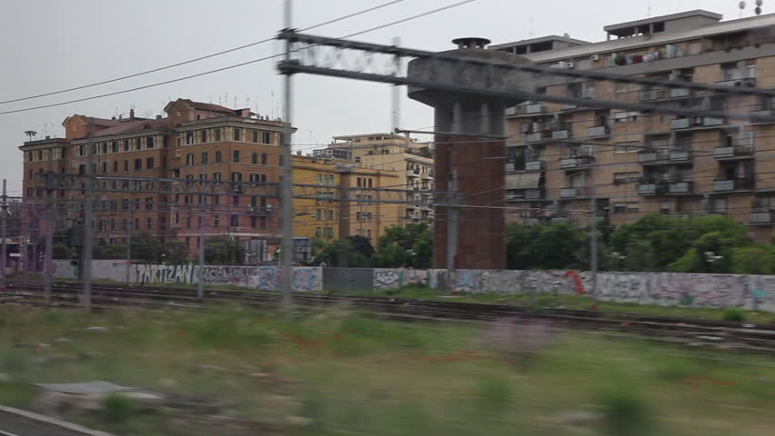 Shot of Italian train station and multistory buildings.