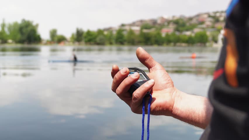 A rowing competition as the stopwatch is pressed, signaling the end of the race. Precise timing for sports events.