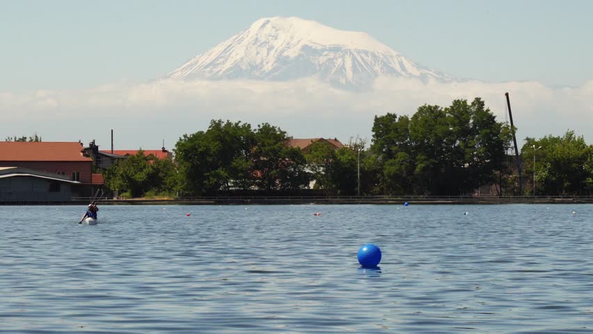 Girls kayaking on a city lake in Yerevan, Armenia, with the Mount Ararat on the background.