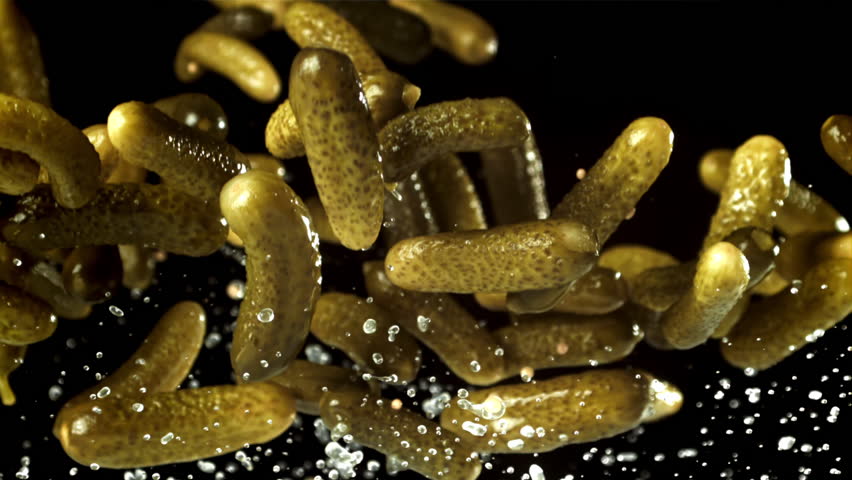Pickled cucumbers fly up and fall down. Filmed on a high-speed camera at 1000 fps. High quality FullHD footage