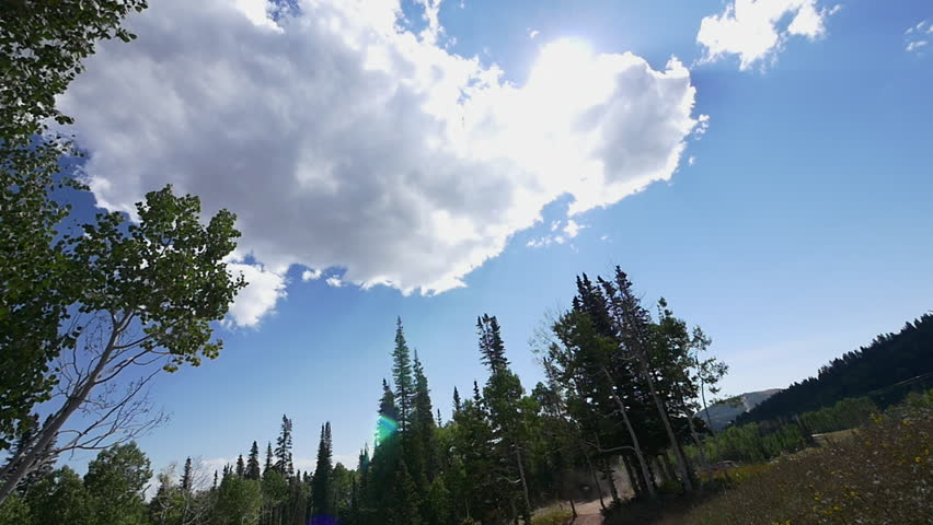 Male, expert mountain biker jumping over camera with sky background at Park City, Utah.
