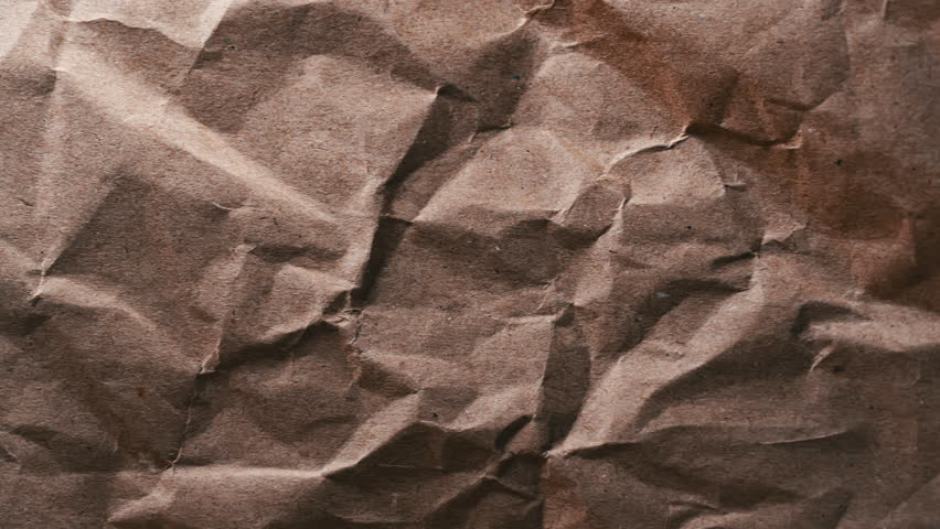 Escape to Green Through Brown Paper. Captures a vibrant green space peeking through a torn hole in crumpled brown paper. Royalty-Free Stock Footage #3442615069