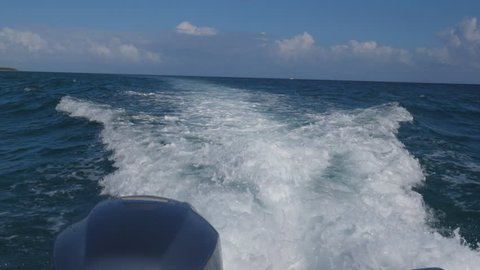 Slow motion view from boat of outboard motor with turbulent, churning white water wake. Note that view is of one motor on twin motor boat. Quintana Roo, Mexico.

