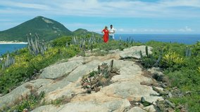Couple standing on the shore beaches of Pontal do Atalaia, Arraial do Cabo, Rio de Janeiro, Brazil. - Powered by Shutterstock - Get 15% off with code: PIKWIZARD15