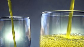 Orange soda is pouring into a two glasses with ice cubes on a white wall background. Overflowing wet 2 glasses with pop orange soda. 4k macro video 60 fps. - Powered by Shutterstock - Get 15% off with code: PIKWIZARD15
