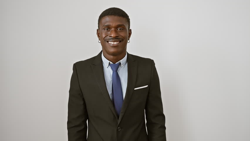 Cool african american man in suit, exuding confidence, joyfully standing, smiling with perfect teeth against an isolated white background