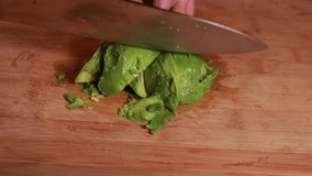 avocado artistry: woman hands cutting avocado on wooden board