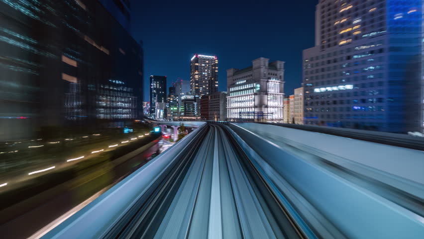 Motion timelapse POV shot from automated train at night in Tokyo, Japan. Royalty-Free Stock Footage #3442787661