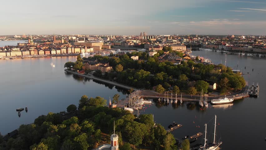 Aerial view of Stockholm at sunrise with lush islands and waterways. Slow drone orbit. Royalty-Free Stock Footage #3442797545
