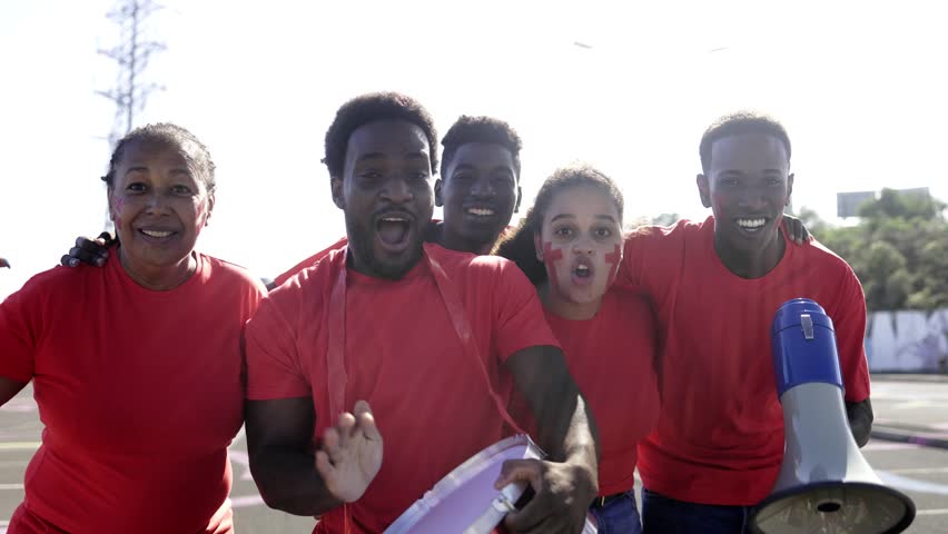 African football sport fans celebrate game in crowd stadium. Soccer red supporters cheering team in championship event - Powered by Shutterstock - Get 15% off with code: PIKWIZARD15