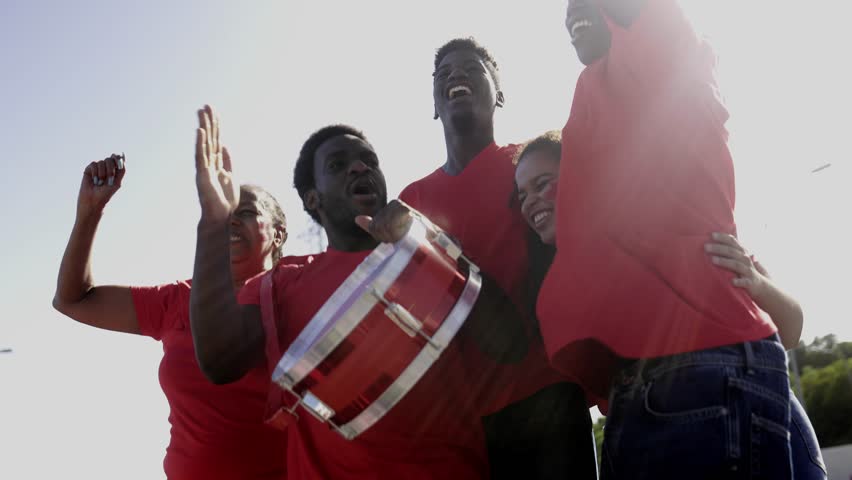 African football sport fans celebrate game in crowd stadium. Soccer red supporters cheering team in championship event - Powered by Shutterstock - Get 15% off with code: PIKWIZARD15