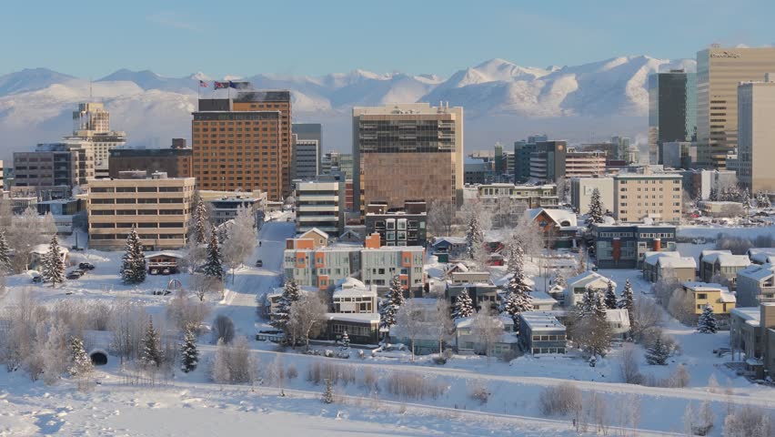 Downtown Anchorage skyline at dusk in the winter covered in snow, Alaska, USA
