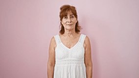 Middle age woman wearing dress standing happy face smiling with crossed arms looking at the camera. positive person. over isolated pink background