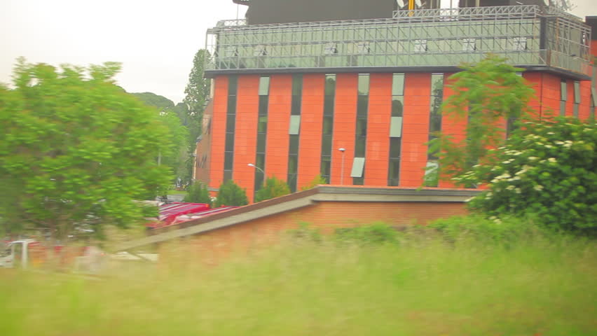 Tracking shot of buildings and trees in Italy