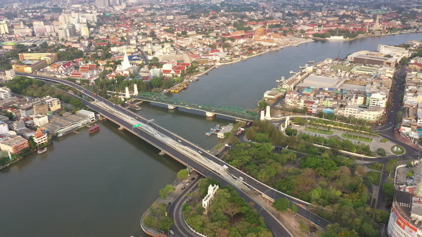 Aerial view of Bangkok city skyline over the Chao Phraya River, Thailand. Asian tourist travel attraction landmark. Asia cityscape, skyscrapers Buildings, boat and car traffic, public transportation.