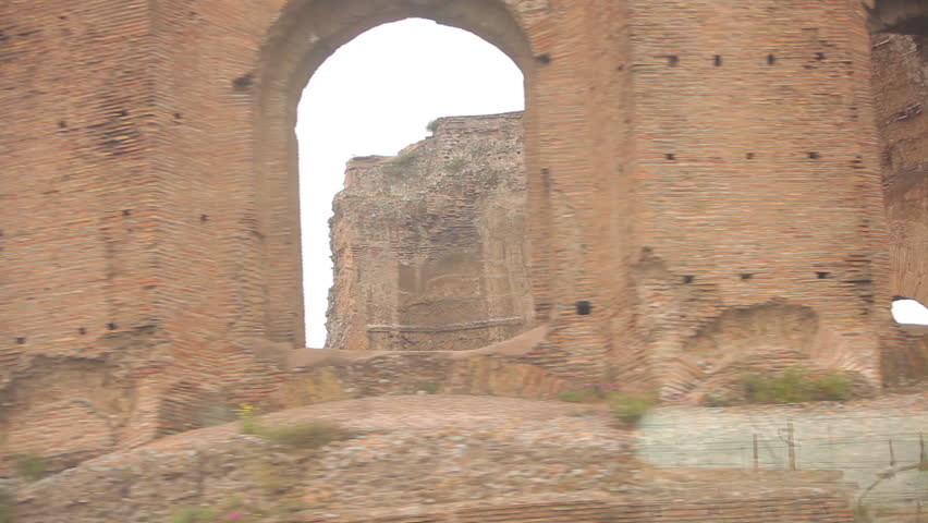 A tracking shot from a tram window between Rome and Venice of decaying ruins. 