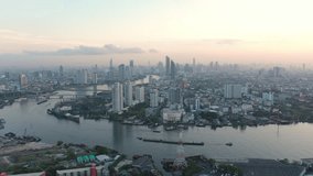 Aerial drone of Skyscrapers Buildings over financial business district in Bangkok Downtown with Chao Phraya River Background. Asian tourist travel attraction city skyline, Traffic and transportation. - Powered by Shutterstock - Get 15% off with code: PIKWIZARD15