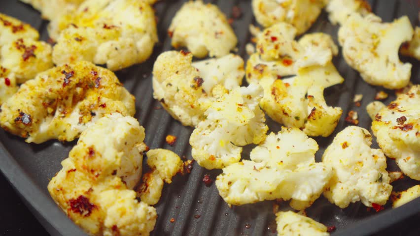 Golden Cauliflower Steaks Sizzling on a Grill Pan, A Modern Vegetarian Delight Royalty-Free Stock Footage #3442944409