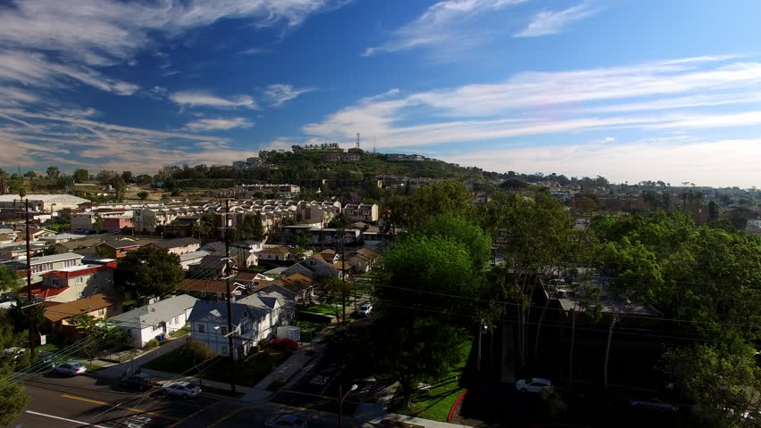 Aerial Forward Shot Of Residential Roofed Houses On City Landscape During Sunny Day Under Clouds - Long Beach, California