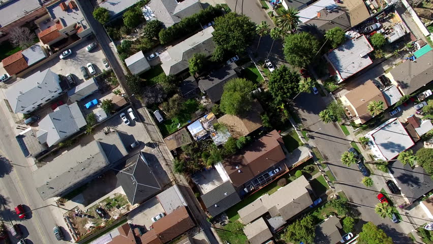 Aerial Tilt Up Backward Shot Of Roofed Houses In Residential City On Sunny Day - Long Beach, California