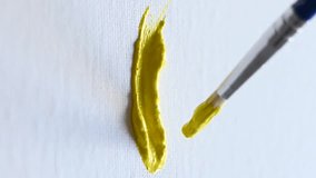 Close-up artist painting with yellow gouache on a white sheet. Vertical video.  - Powered by Shutterstock - Get 15% off with code: PIKWIZARD15