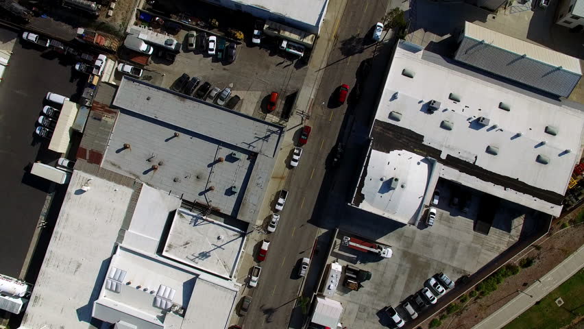 Aerial Top Forward Shot Of Cars Parked In Parking Lot Of City On Sunny Day - Long Beach, California