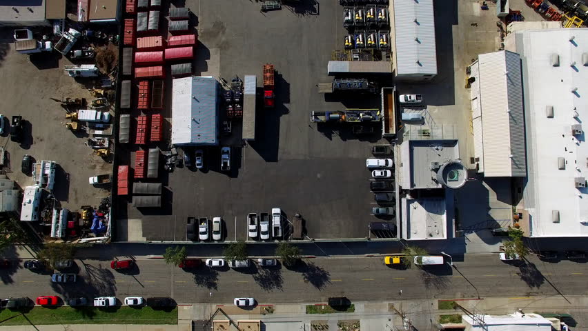 Aerial Top Forward Shot Of Cars Parked In Parking Lot On Sunny Day - Long Beach, California