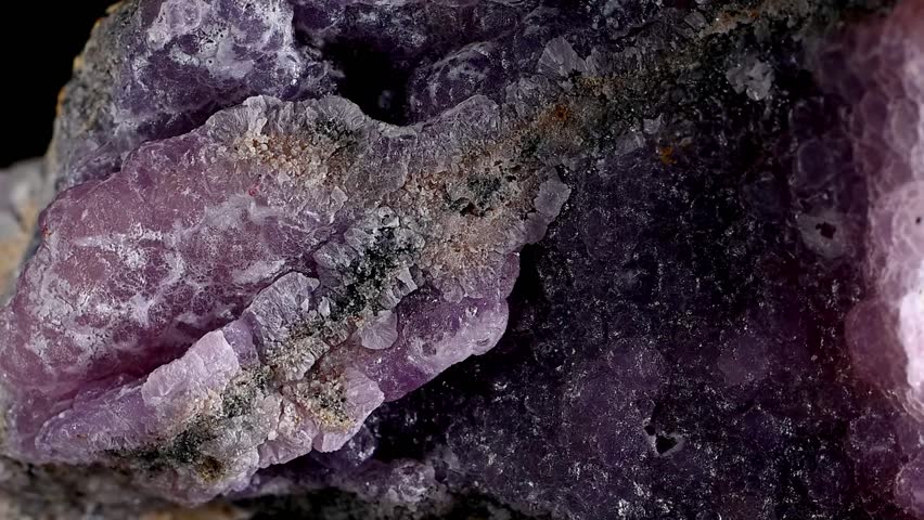 Purple botryoidal Smithsonite (zinc carbonate) crystals rotating slowly against a black background