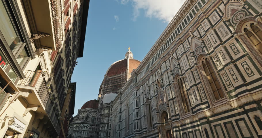 The facade of the Basilica of Santa Maria del Fiore in Florence, Italy. A beautiful shot from the stabilizer of the passage under the walls with frescoes of the cathedral. High quality 4k footage Royalty-Free Stock Footage #3443091457