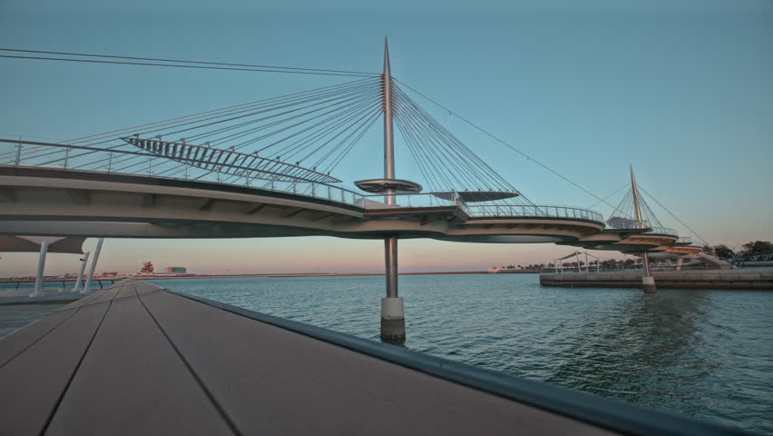 The Lusail Pedestrian Bridges, also  known as the Glass Bridge of Lusail, In Lusail city, Qatar is a suspension bridge that runs across Qetaifan Island South 1, 2 and 3.  Royalty-Free Stock Footage #3443093443