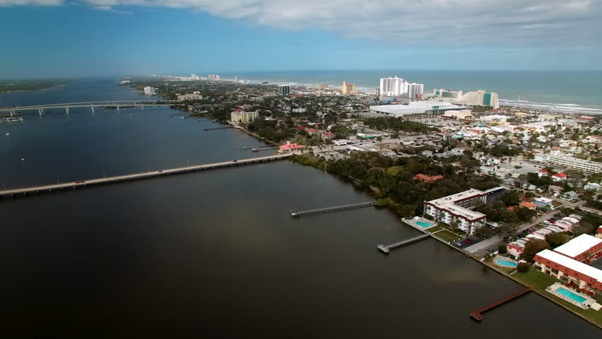 Aerial Panning Scenic View Of Segmental Bridge And Causeway Over Tranquil River Under Clouds - Daytona Beach , Florida