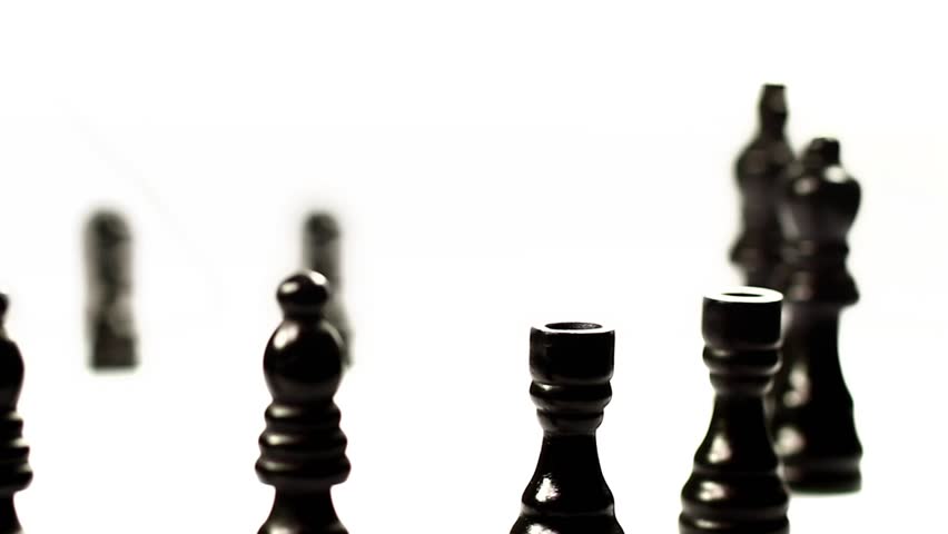 Chess set's march. Black chess pieces crossing in a row. 
