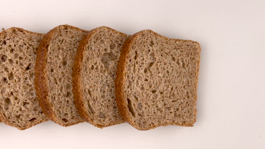 Slices of whole wheat bread.  Dolly shot in top view