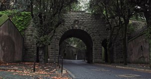 Background video of an old stone wall of a bridge with an arch on the road. High quality 4k footage