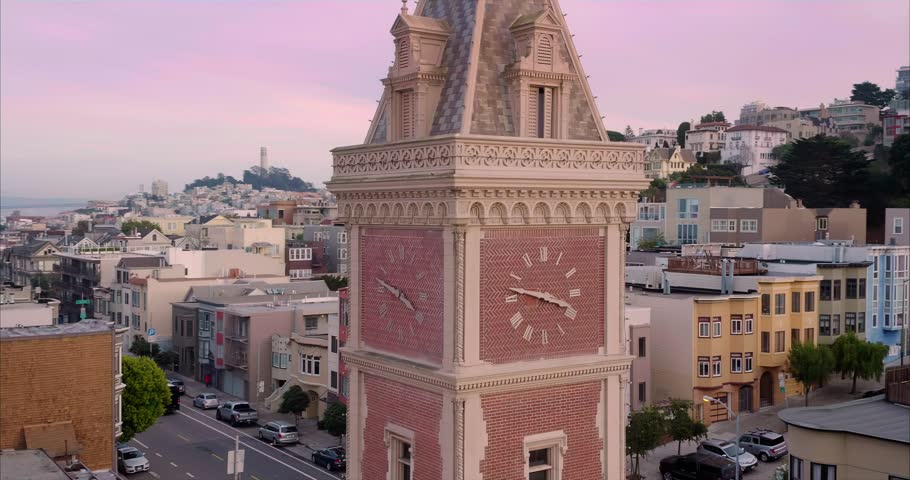 Aerial flying over Ghirardelli Square and clock tower in San Francisco at sunset. California, USA