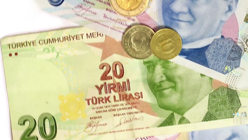 Coins over banknotes. Looping clip of Turkish bills passing in front of camera.