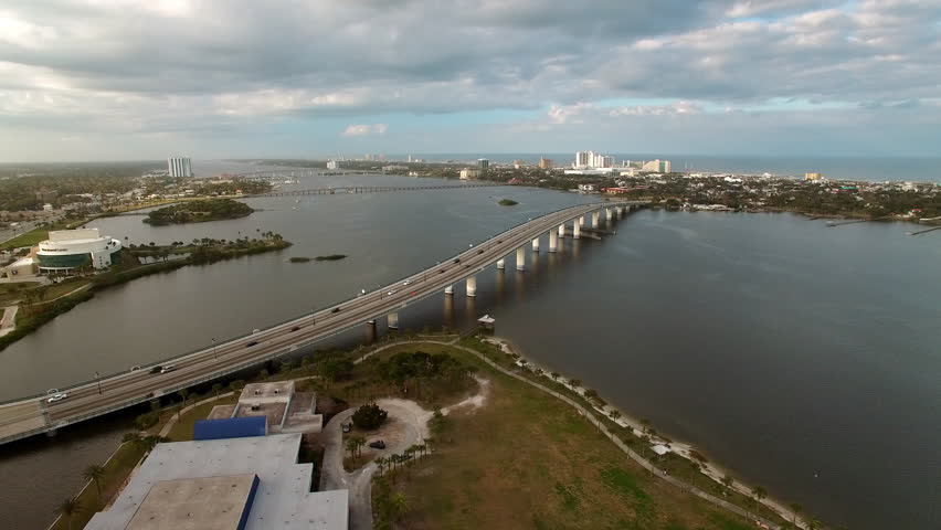 Aerial Panning Beautiful View Of Segmental Bridge Over River Under Cloudy Sky - Daytona Beach , Florida