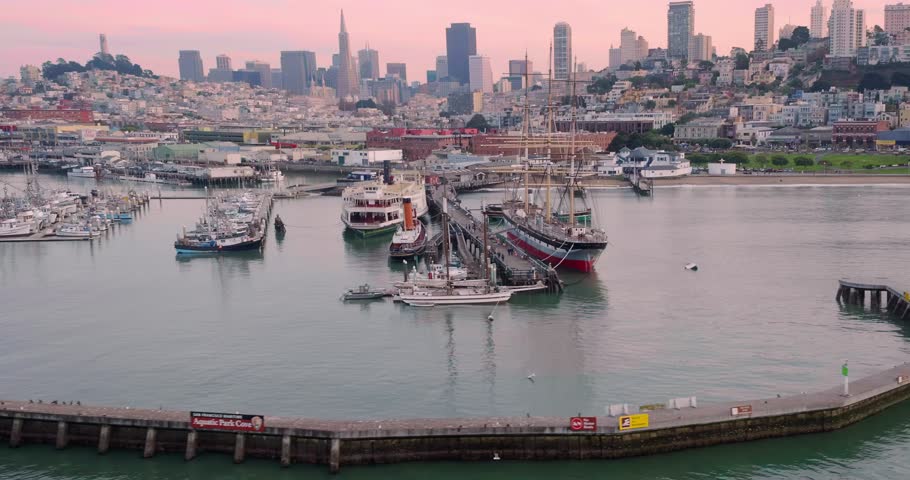 Aerial: Boats docked at Aquatic park and fisherman