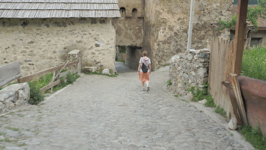 Girl walks in the old city Mestia, Georgia