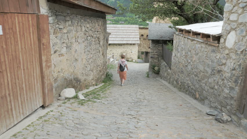 Girl walks in the old city Mestia, Georgia