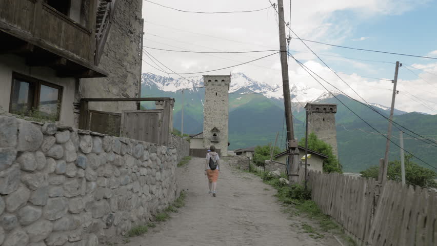 Girl walks in the old city Mestia, Georgia