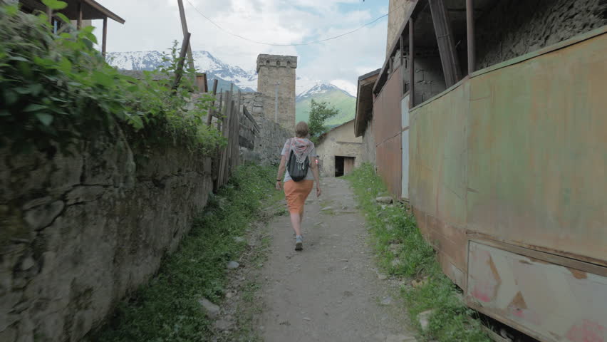 Girl walks in the old city Mestia, Georgia