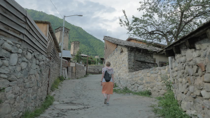 Girl walks in the old city Mestia, Georgia