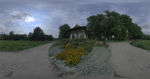 This 360-degree video takes you on a journey through a stunning garden, filled with vibrant flowers and lush greenery. The centerpiece of the garden is a traditional house, with its charming
