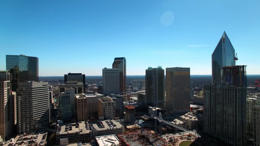 Aerial Shot Of Modern Buildings In Residential City Against Clear Sky, Drone Flying Backwards On Sunny Day - Charlotte, North Carolina