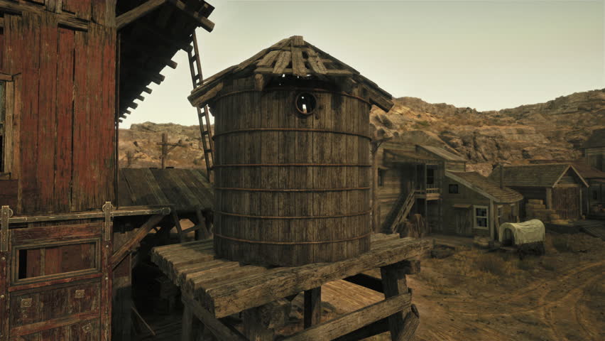 An old wooden building with a water tower next to it