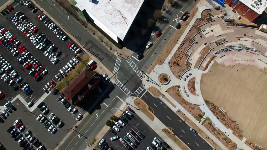 Aerial Tilt Up Shot Of Modern Buildings In Downtown District Against Sky, Drone Flying Over Parking Lot On Sunny Day - Charlotte, North Carolina