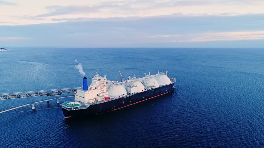 Aerial of Liquified Natural Gas LNG carrier moored to a small gas terminal. Fuel crisis. Sanctions