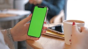 Businesswoman, hands or green screen phone in coffee shop, restaurant or cafe on social media app or calendar management. worker employee or mobile technology mockup of office logo on lunch break 4K