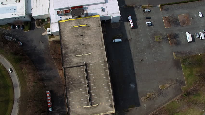 Aerial Forward Tilt Up Shot Of Parking Lot By Modern Financial District - Charlotte, North Carolina